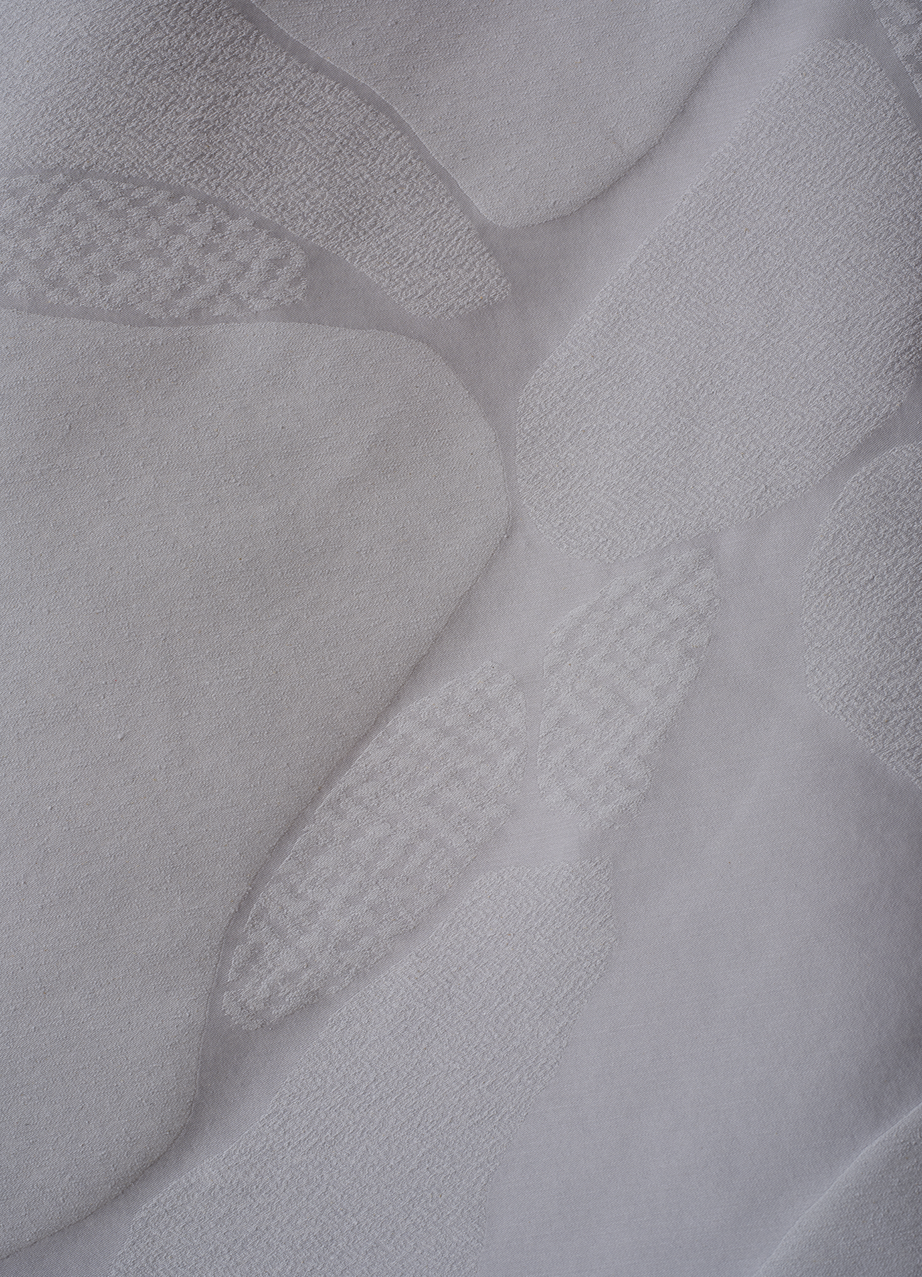 Multi-textured surface with allover design inspired by stones