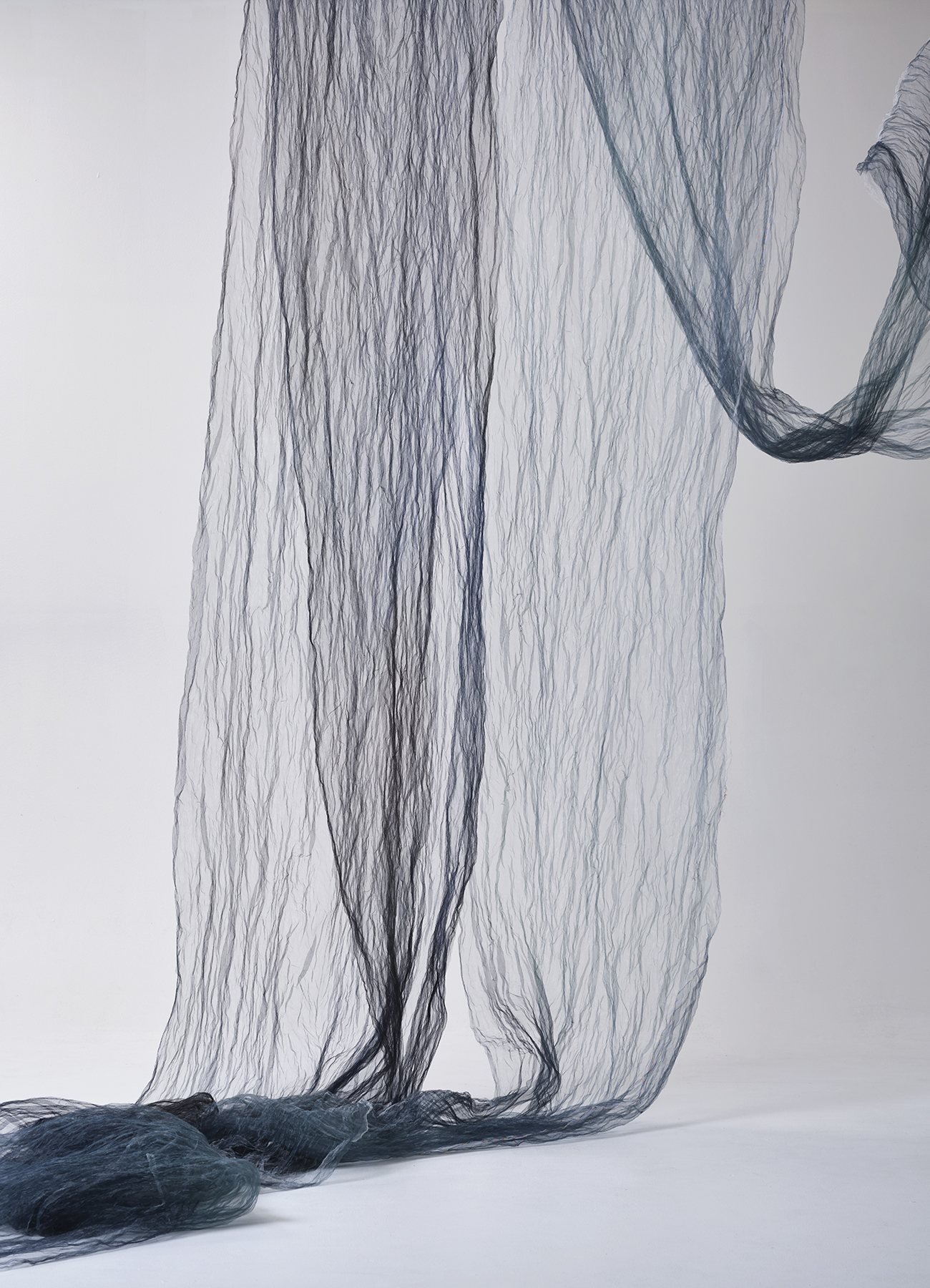 Light sheer metal fabric with vertical plissé and allover color blur print